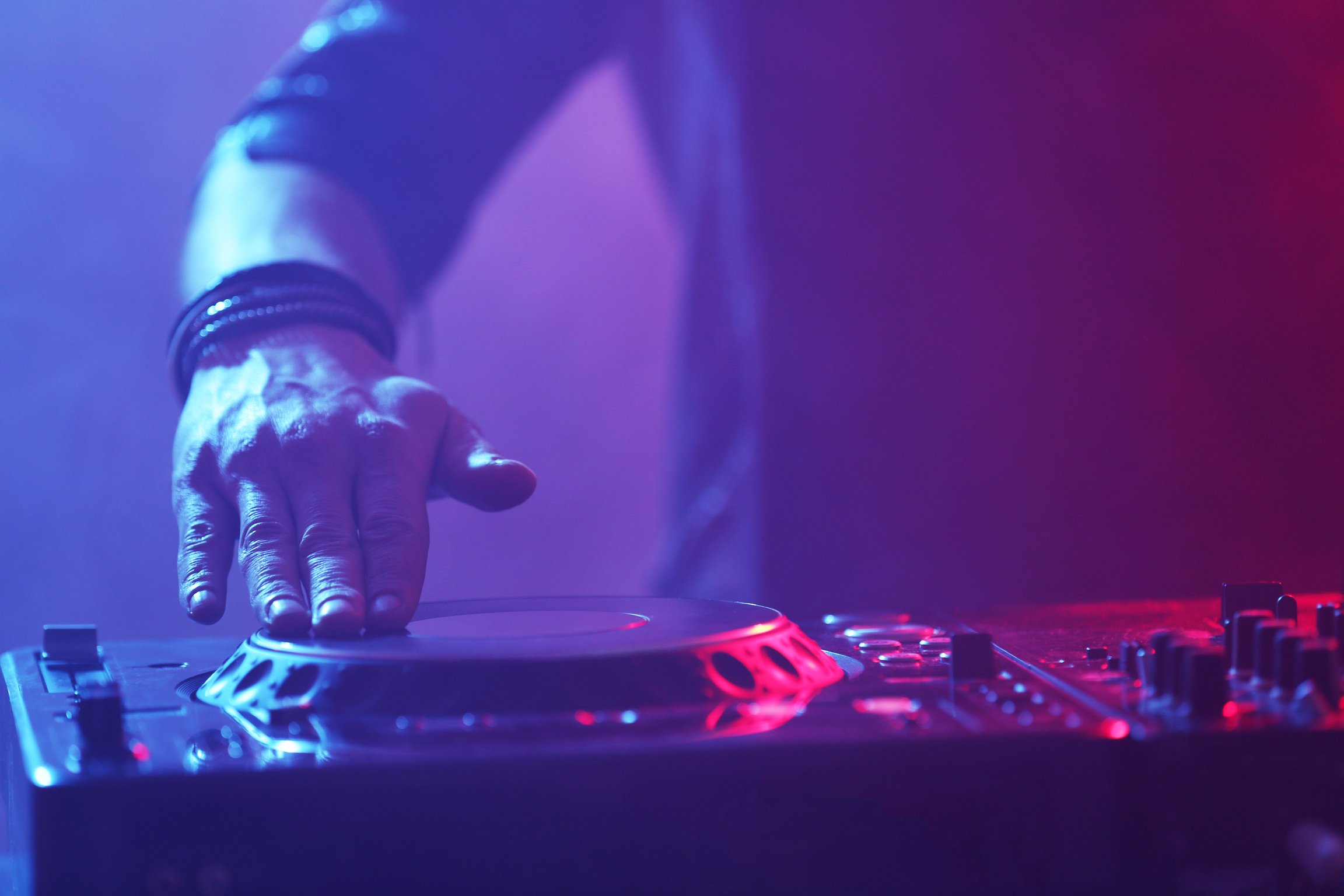 DJ Playing Music on a Mixer Up Close 